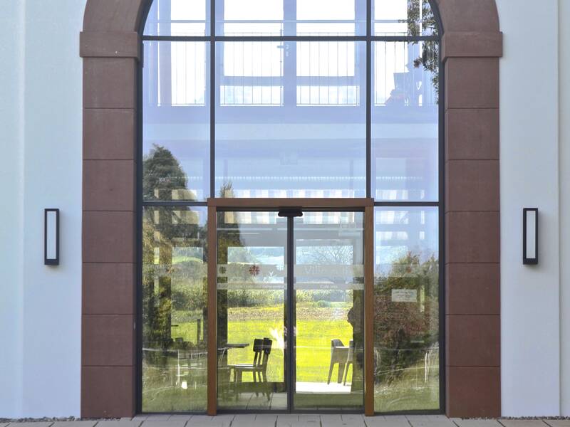 Der Eingang zur Villa artis, mit großer Glasfront.